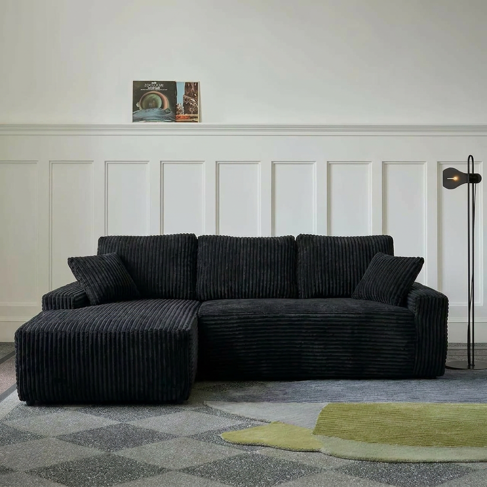 Black L-shaped Boneless Couch with a left-facing chaise on a patterned rug