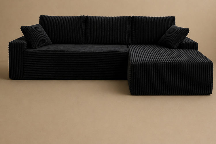Black 96-inch-style L-shaped corduroy couch shown against a plain warm background