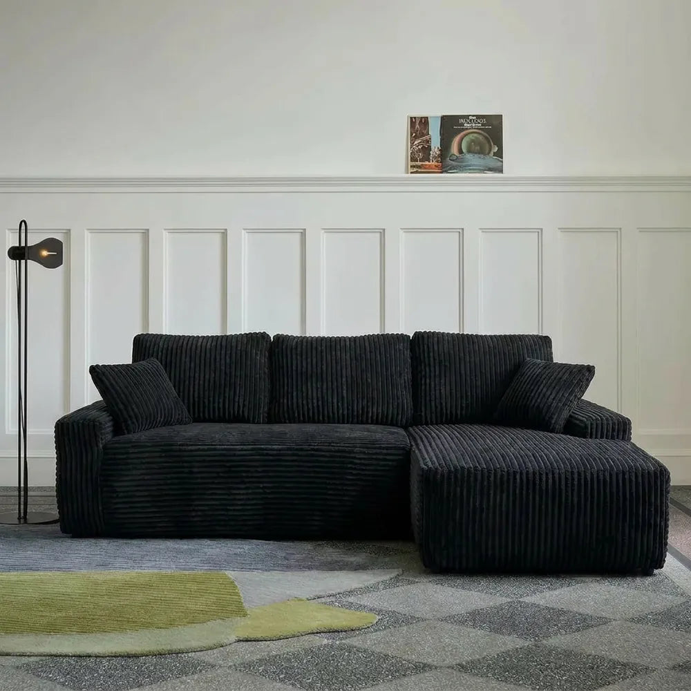 96-inch black L-shaped modular sofa in a modern living room
